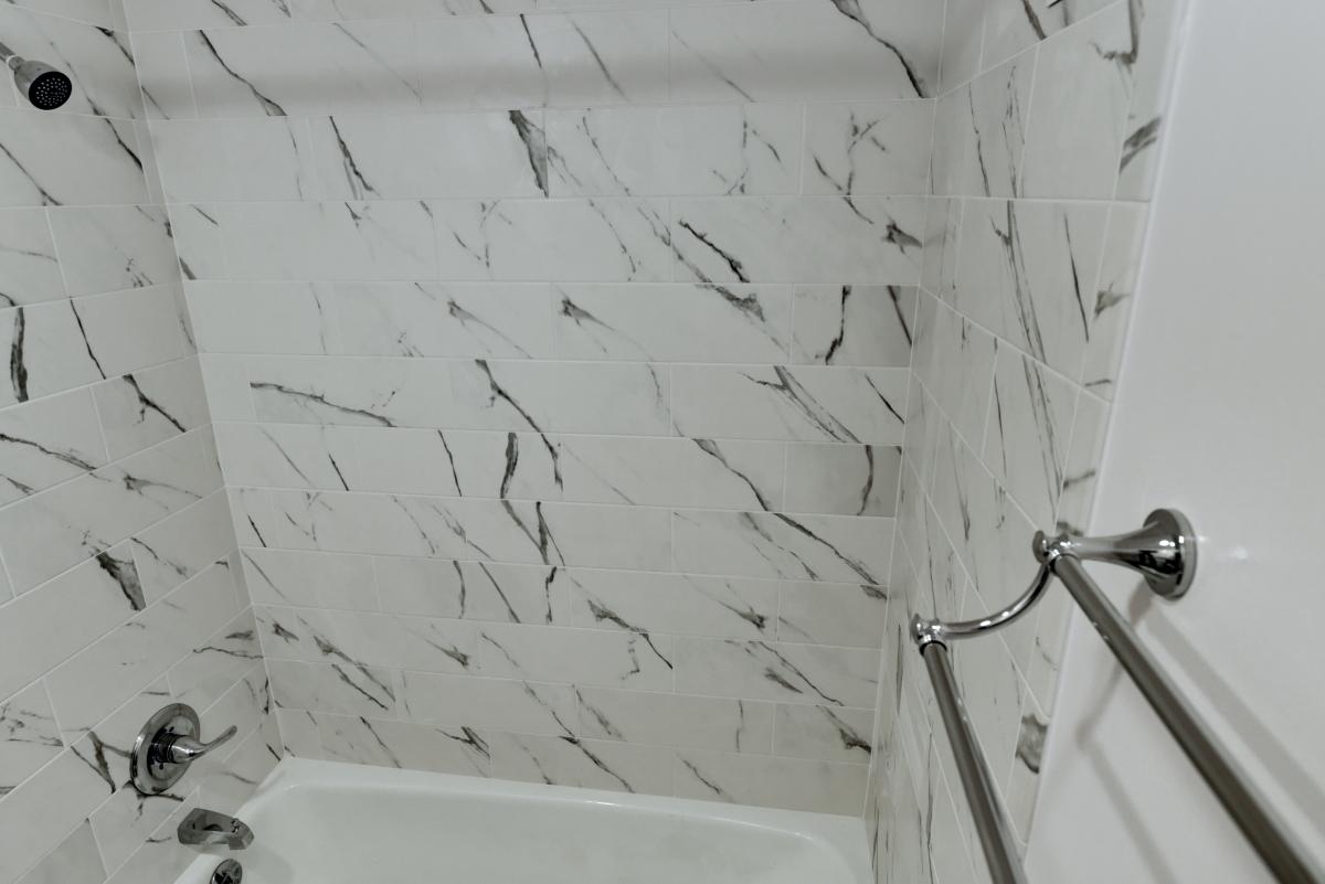 Bathtub and shower detail. Willoughby Studio Apartment For Rent in Heart of Chevy Chase, MD: Phone or text Don at 805-276-0689