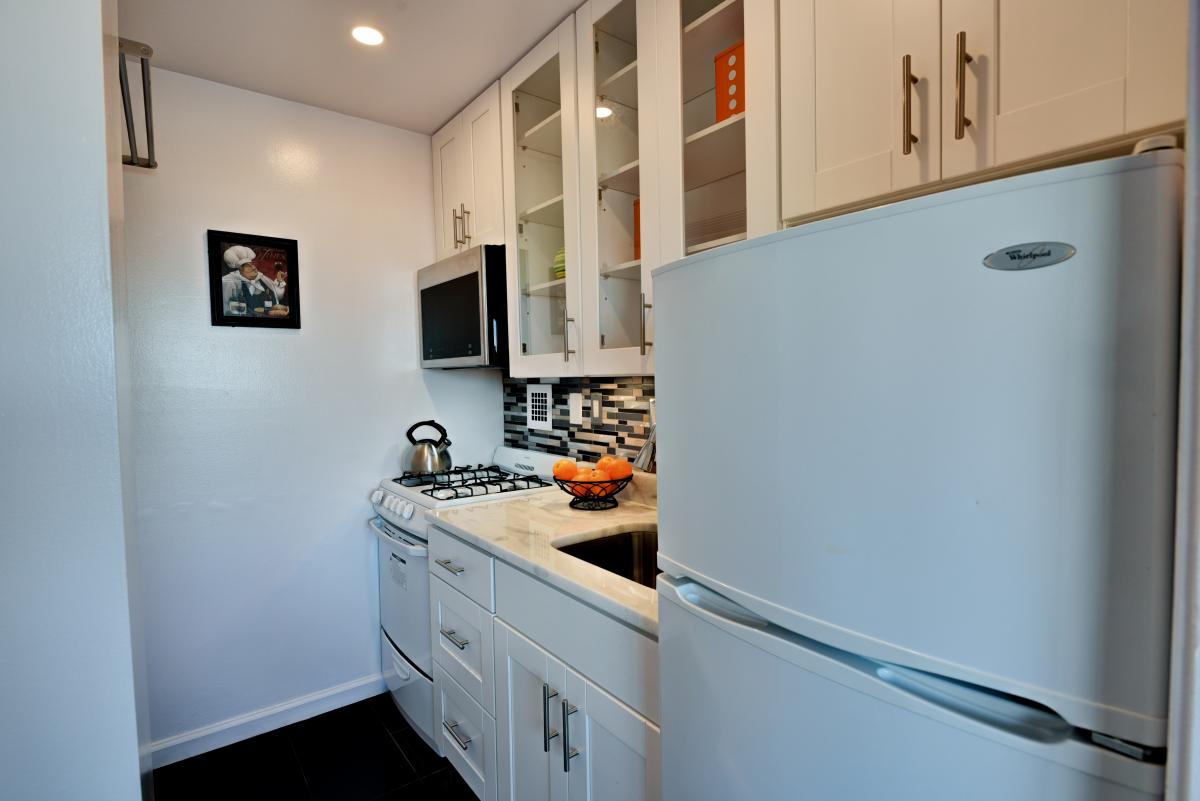 Willoughby Studio Apartment: Bright, cheerful kitchen has pocket door to close off from dining area ... perfect to prepare surprise dishes for presentation!